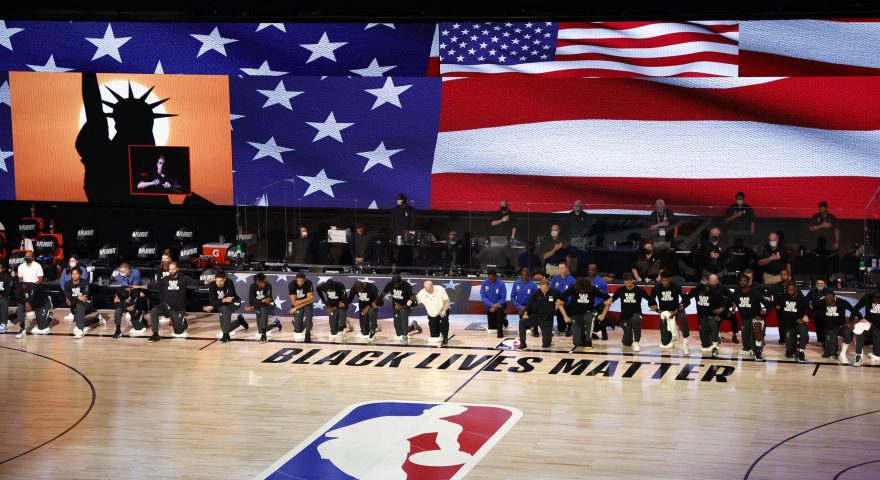epa08623202 Members of the Orlando Magic and the Milwaukee Bucks take a knee during the national anthem before their NBA basketball first-round playoff game four at the ESPN Wide World of Sports Complex in Kissimmee, Florida, USA, 24 August 2020.  EPA/JOHN G. MABANGLO SHUTTERSTOCK OUT